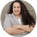 Professional headshot of Jennine Morel with arms crossed.